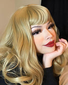 Ash blonde 50s style wig with short fringe and gentle waves: Trinity