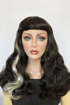 Long black 1950s pin up style wig with platinum streak and retro fringe: Michelle AnnabellesWigs